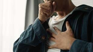 A person covers their cough
