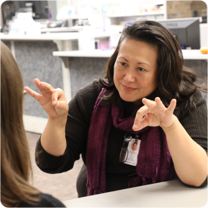 Health Department employee helps a customer using American Sign Language ASL
