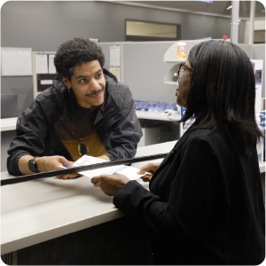 Health Department employee helps a customer at the front counter