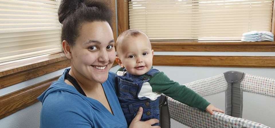 Smiling woman holding happy baby