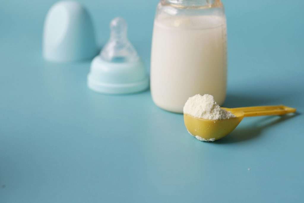 Baby formula in a scoop and bottle